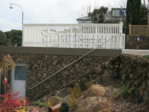 Natural stone facade on side garage wall.